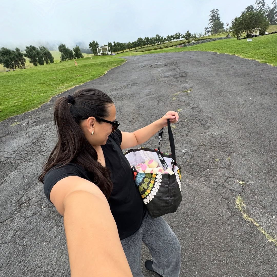 Carrying the insulated cooler of cups to a Maui event