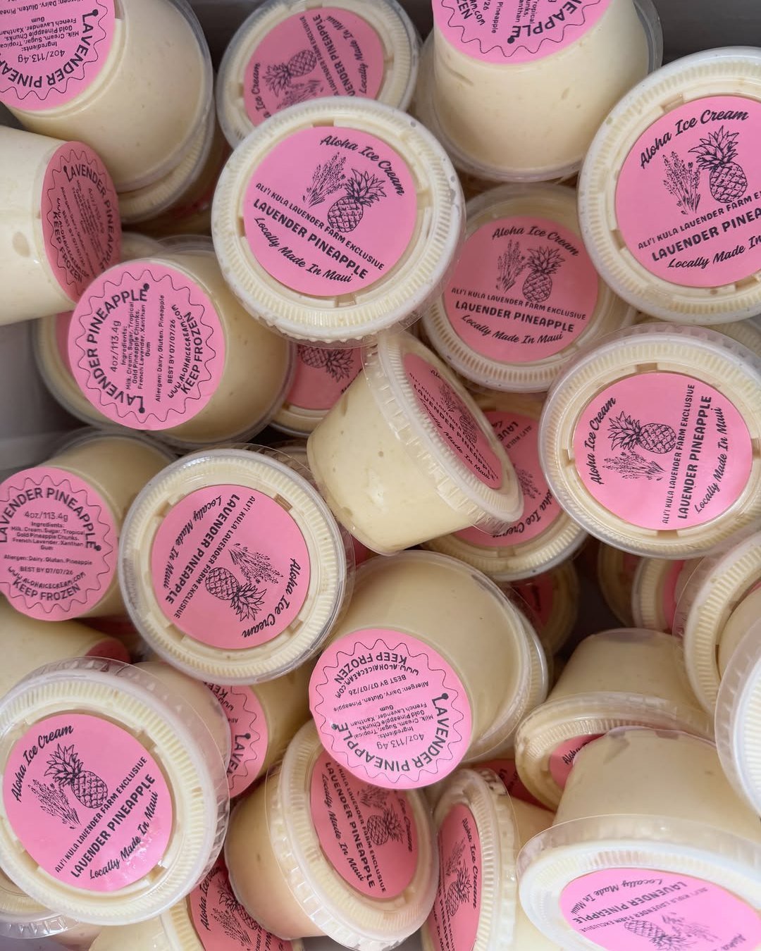 A pile of Aloha Ice Cream's pink-labeled Lavender Pineapple cups, locally made on Maui